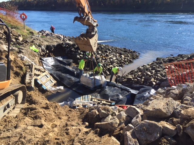 A construction site with a crane and rocks