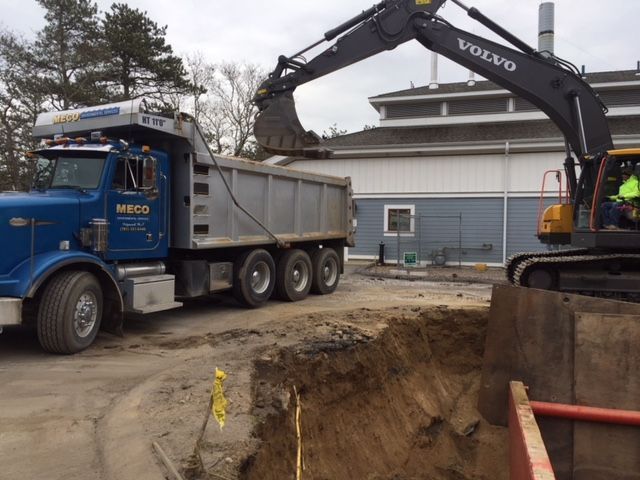 A large excavator loading a truck