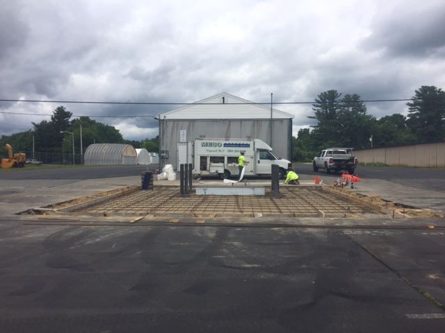 A construction site with a truck and a building