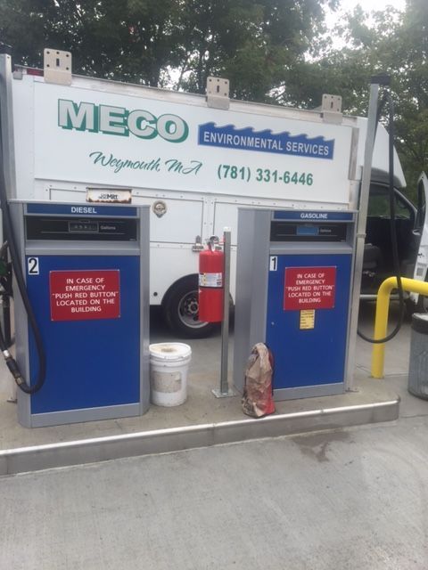 A gas station with a truck and a gas pump