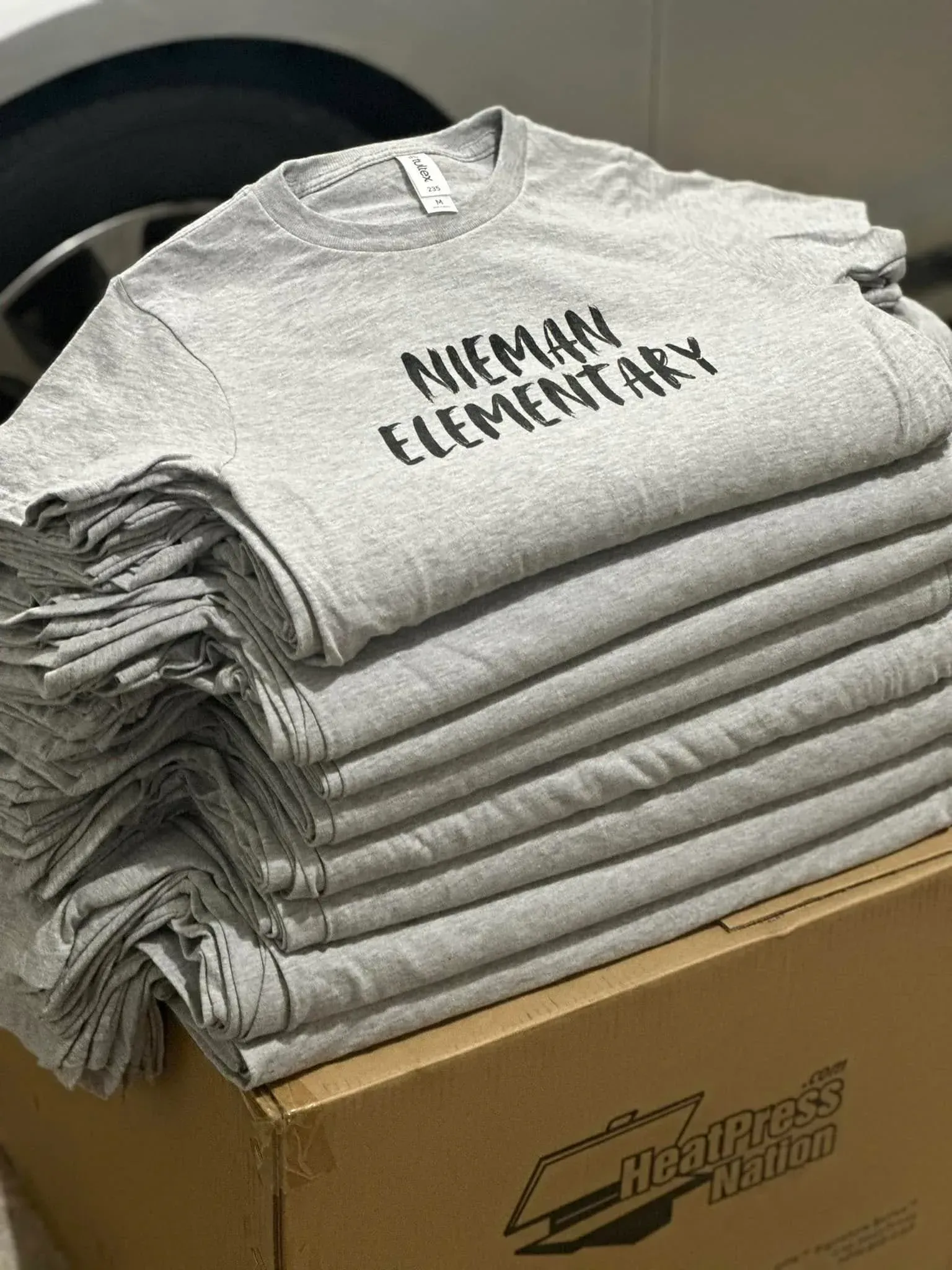 Stack of gray t-shirts printed with