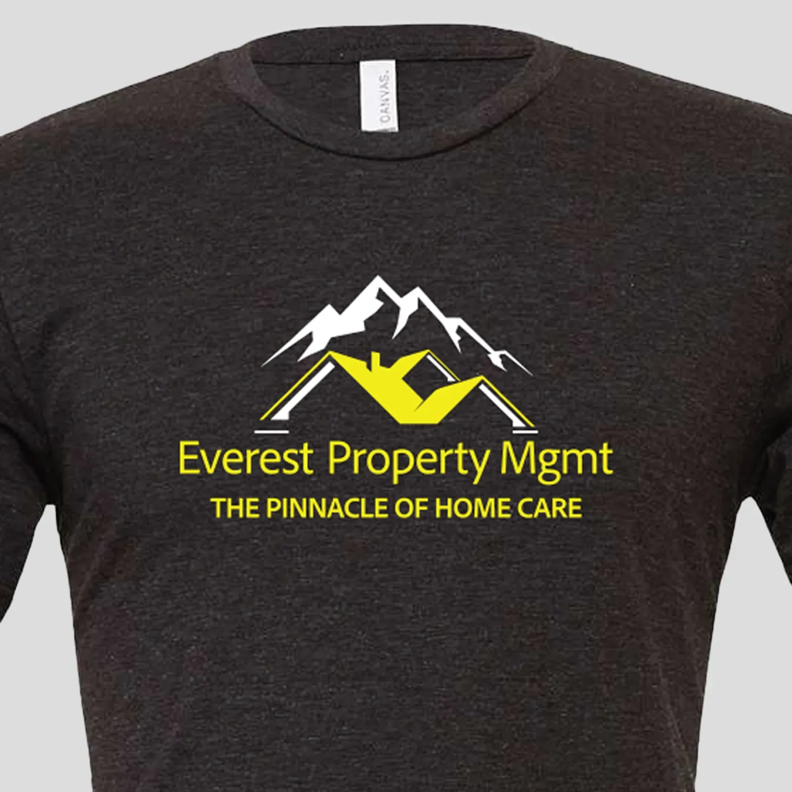 Dark gray t-shirt with Everest Property Mgmt logo: yellow text, white mountains, yellow roof. 