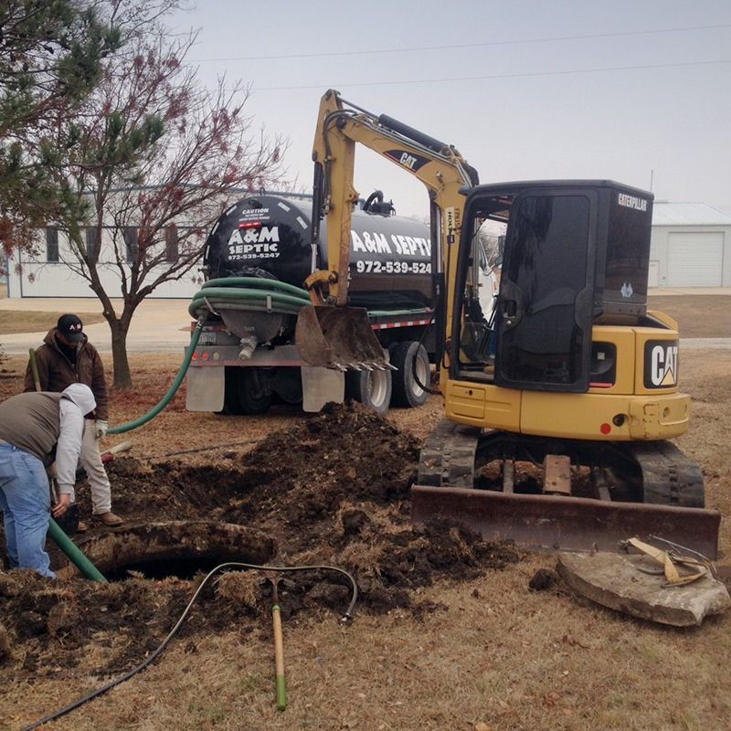 Septic tank service: Crew members working, excavator, and tank truck on site.