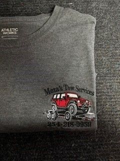 Gray sweatshirt with a tow service logo, red tow truck graphic, and phone number