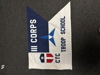 III Corps Troop School banner with blue, white, and red sections and a star emblem