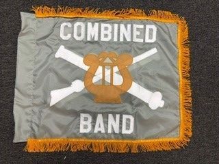 Gray flag with orange fringe reading “COMBINED BAND” and a crossed white symbol over an orange emblem.