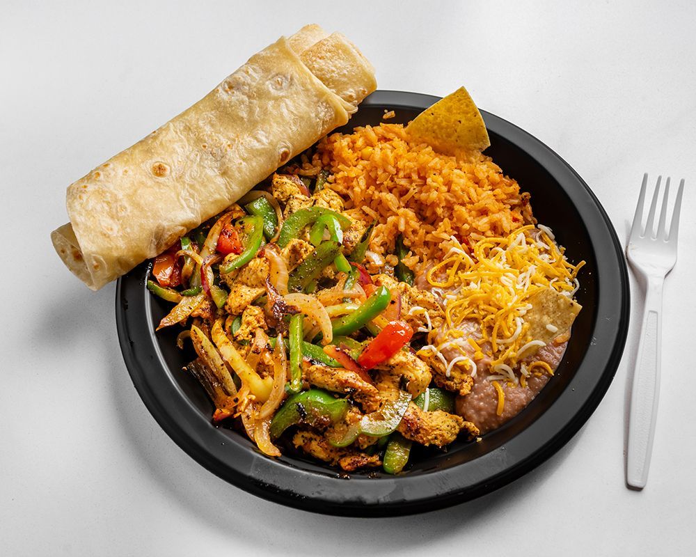 Mexican food plate: Fajitas with rice, beans, cheese, tortilla wrap, and a chip, with a fork.