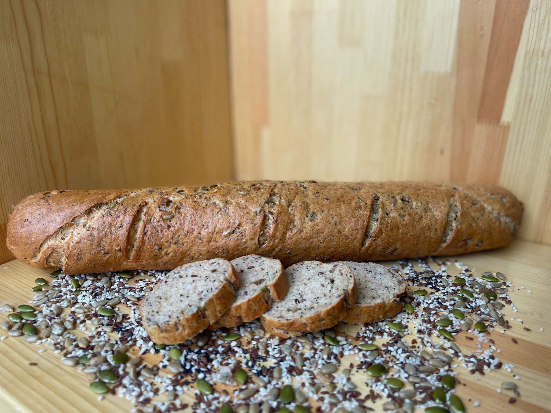 A loaf of bread is sitting on top of a wooden table.