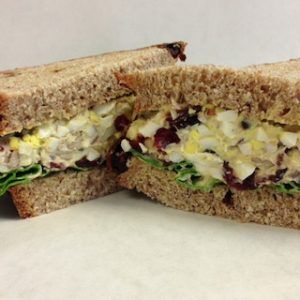 A close up of a sandwich cut in half on a table.