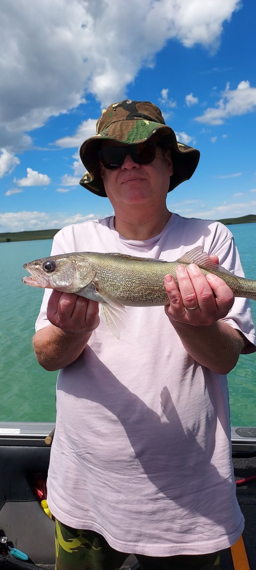 A man is holding a fish in his hands