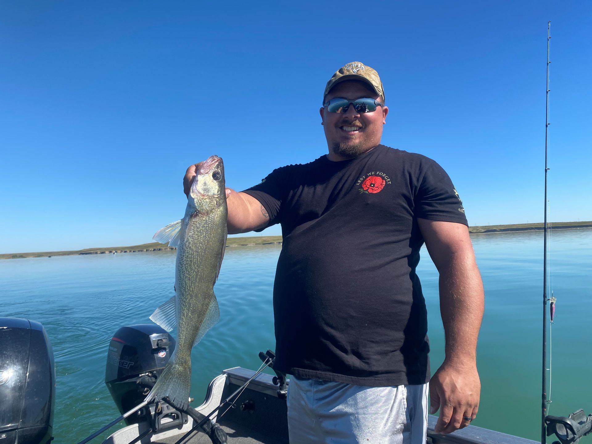 a man is standing on a boat holding a large fish.