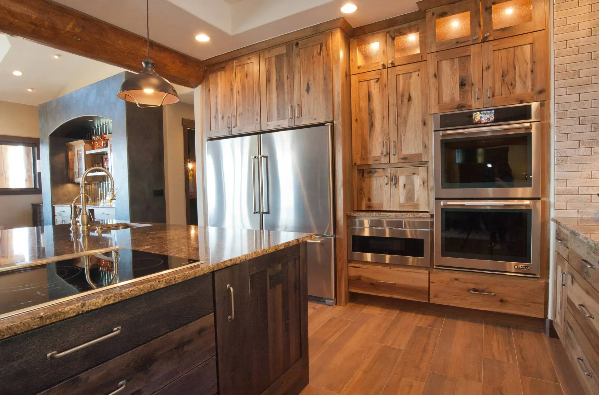 Rustic kitchen with wood cabinets, stainless steel appliances, and island.