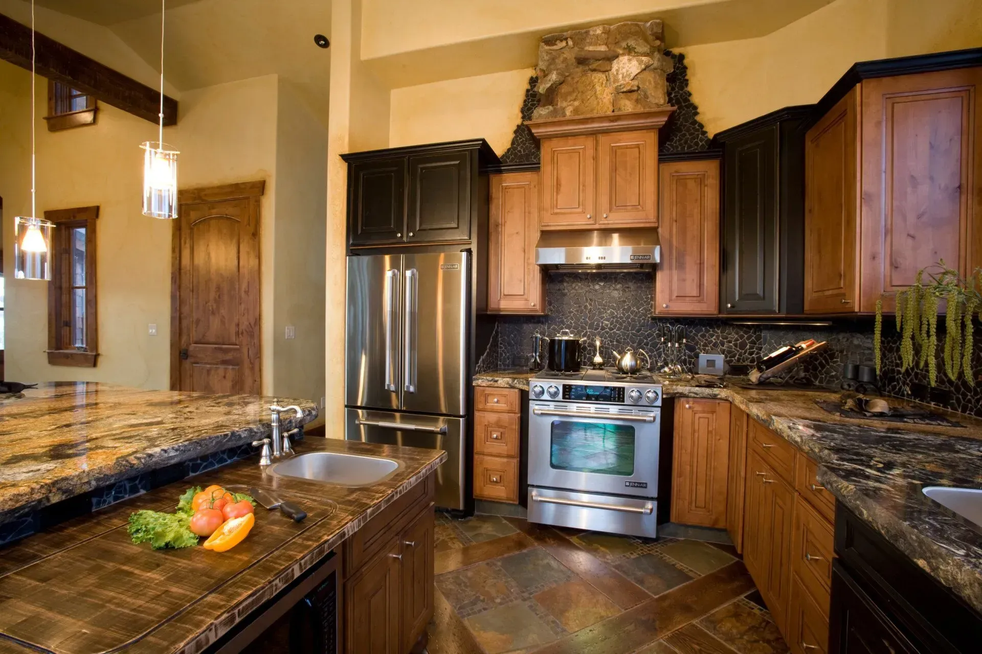 Kitchen with granite countertops, stainless steel appliances, and wooden cabinets.