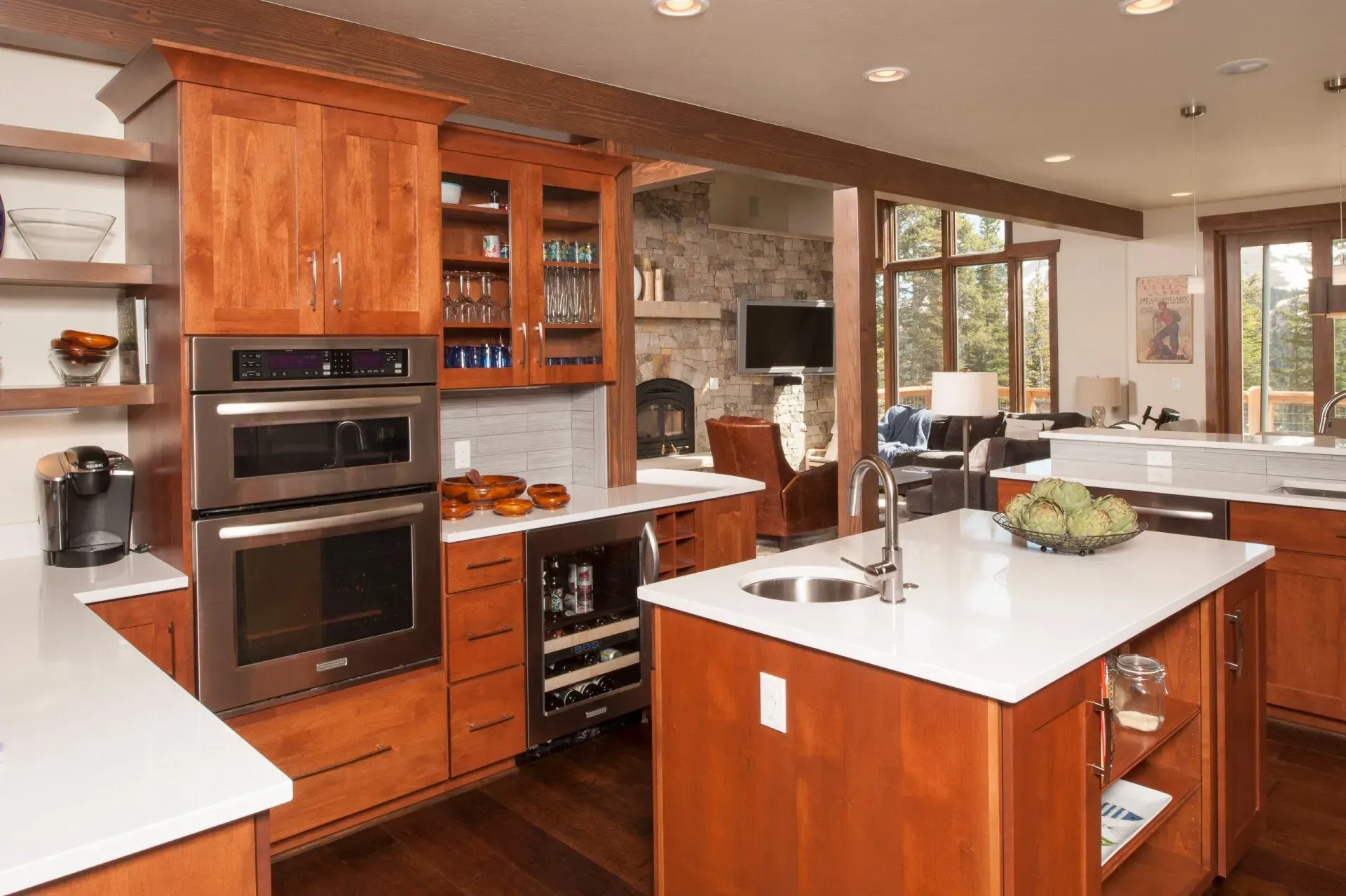 Kitchen with wooden cabinets, white countertops, stainless steel appliances, and an island.