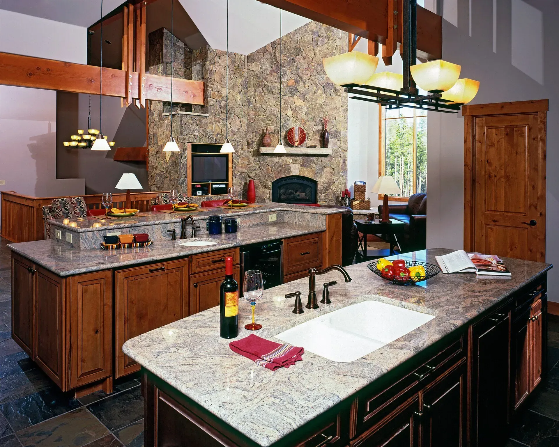 Spacious kitchen with granite countertops, wooden cabinets, and a stone accent wall.