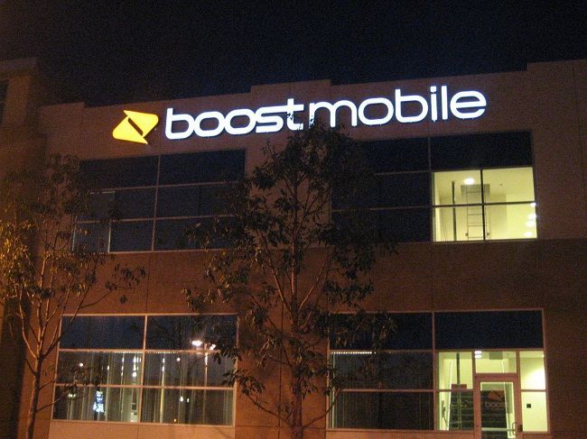 A boostmobile building is lit up at night