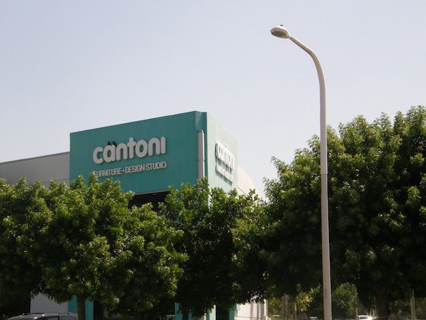 A cantoni building is surrounded by trees and a street light