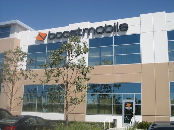 A boostmobile building with cars parked in front of it