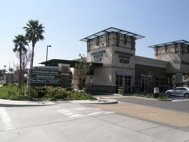 A building with a sign that says ' starbucks coffee ' on it
