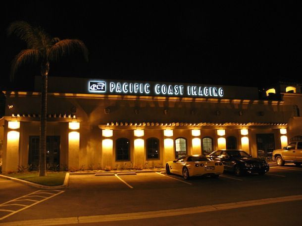 A pacific coast airlines building is lit up at night