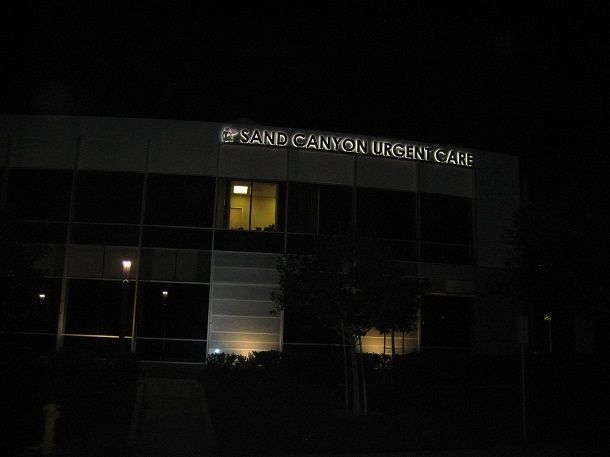 The pearl canyon urgent care center is lit up at night.