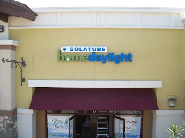 A store front with a sign that says solatube home daylight