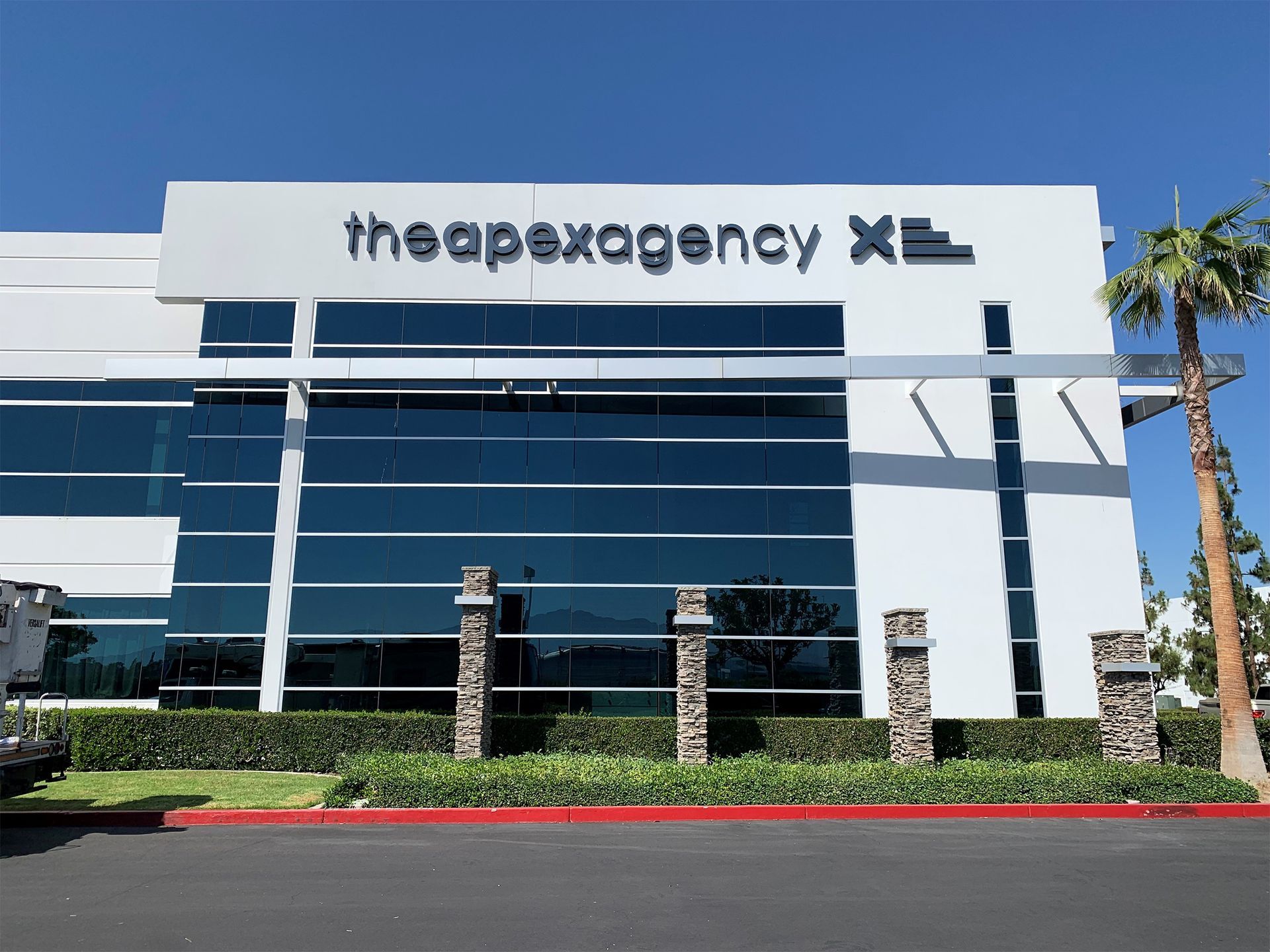 A large white building with the apexagency written on it