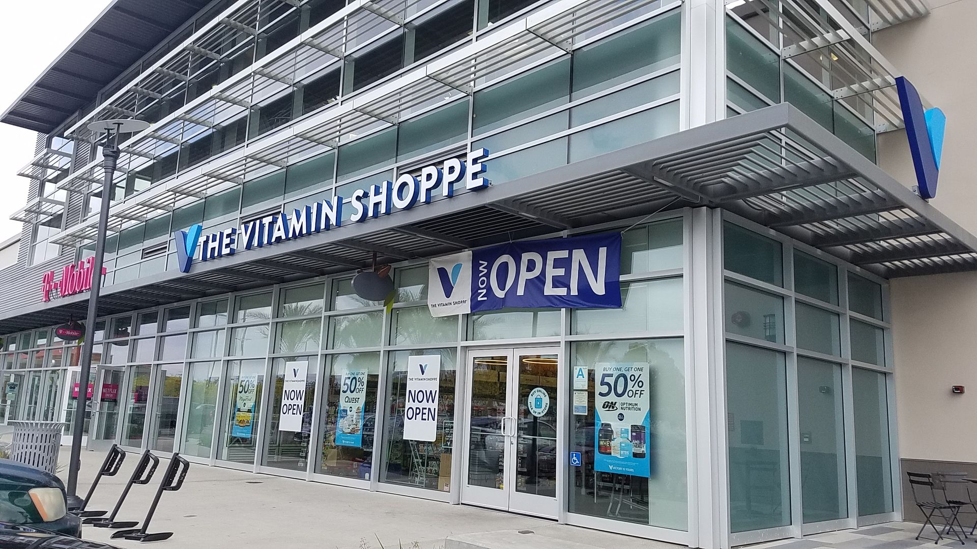 A store front with a blue sign that says `` open ''.