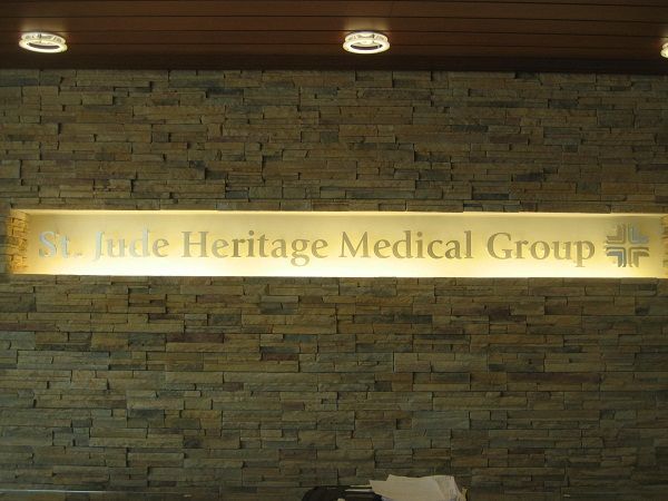 A brick wall with a sign that says st jude heritage medical group