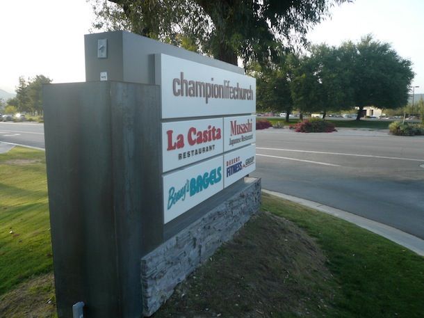 A building with a sign that says mrbell realtors quiznos sub