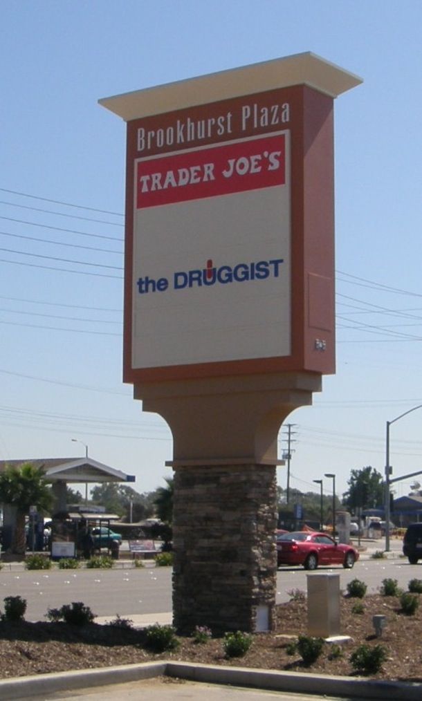 A sign for brookhurst plaza trader joe 's and the droggist