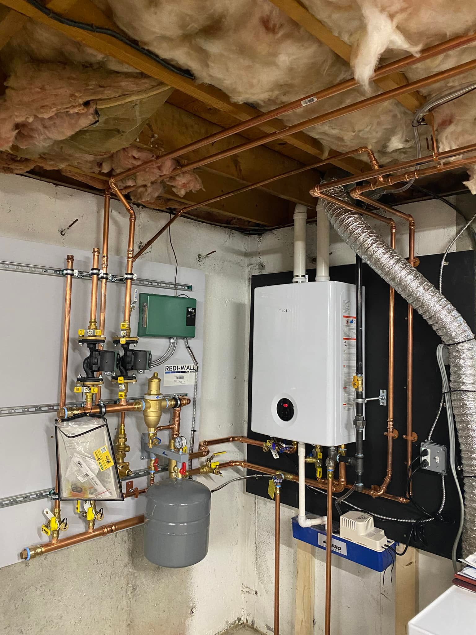 Copper pipes and heating equipment installed in a basement.