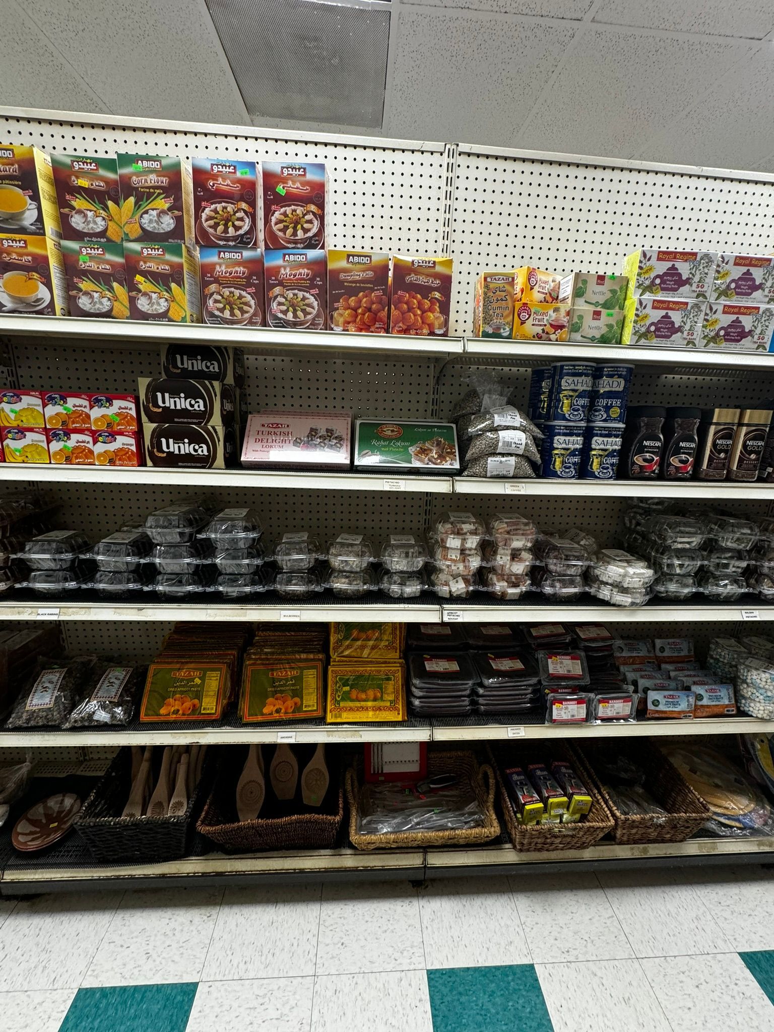 Grocery shelf stocked with assorted packaged snacks and desserts in a store aisle
