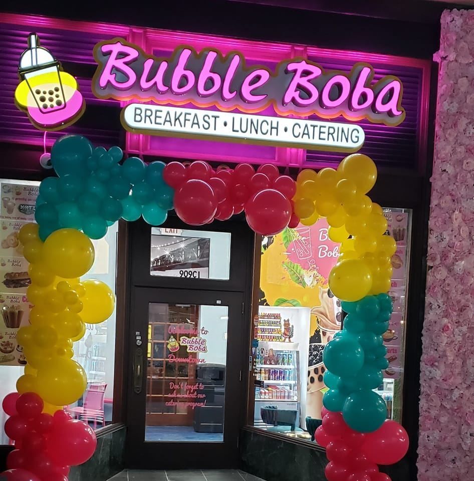 A bubble boba restaurant with balloons in front of it