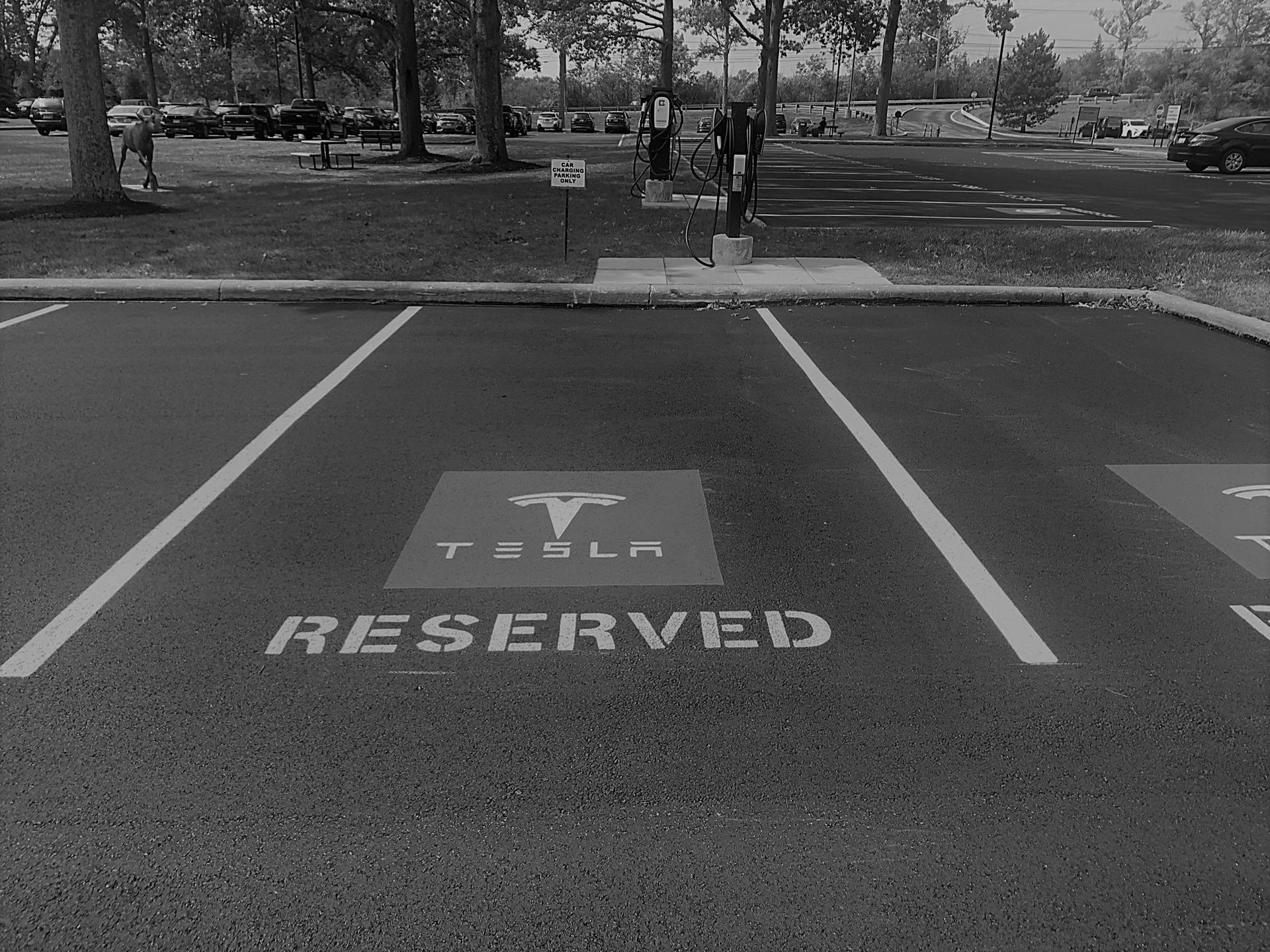 A black and white photo of a reserved parking spot