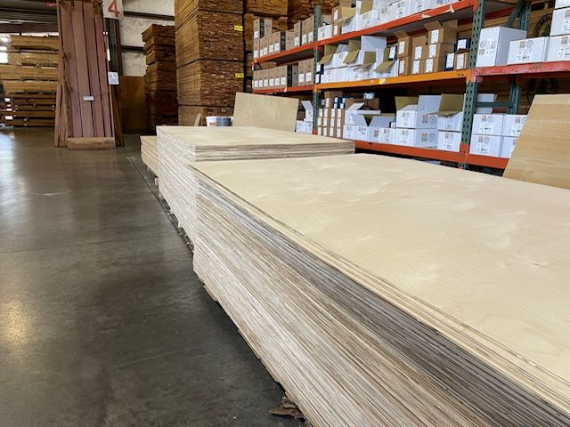A large stack of plywood in a warehouse