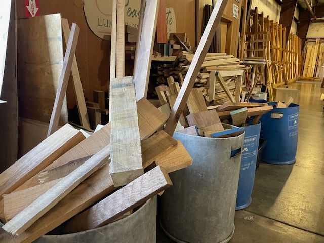 A bunch of buckets filled with wood in a workshop