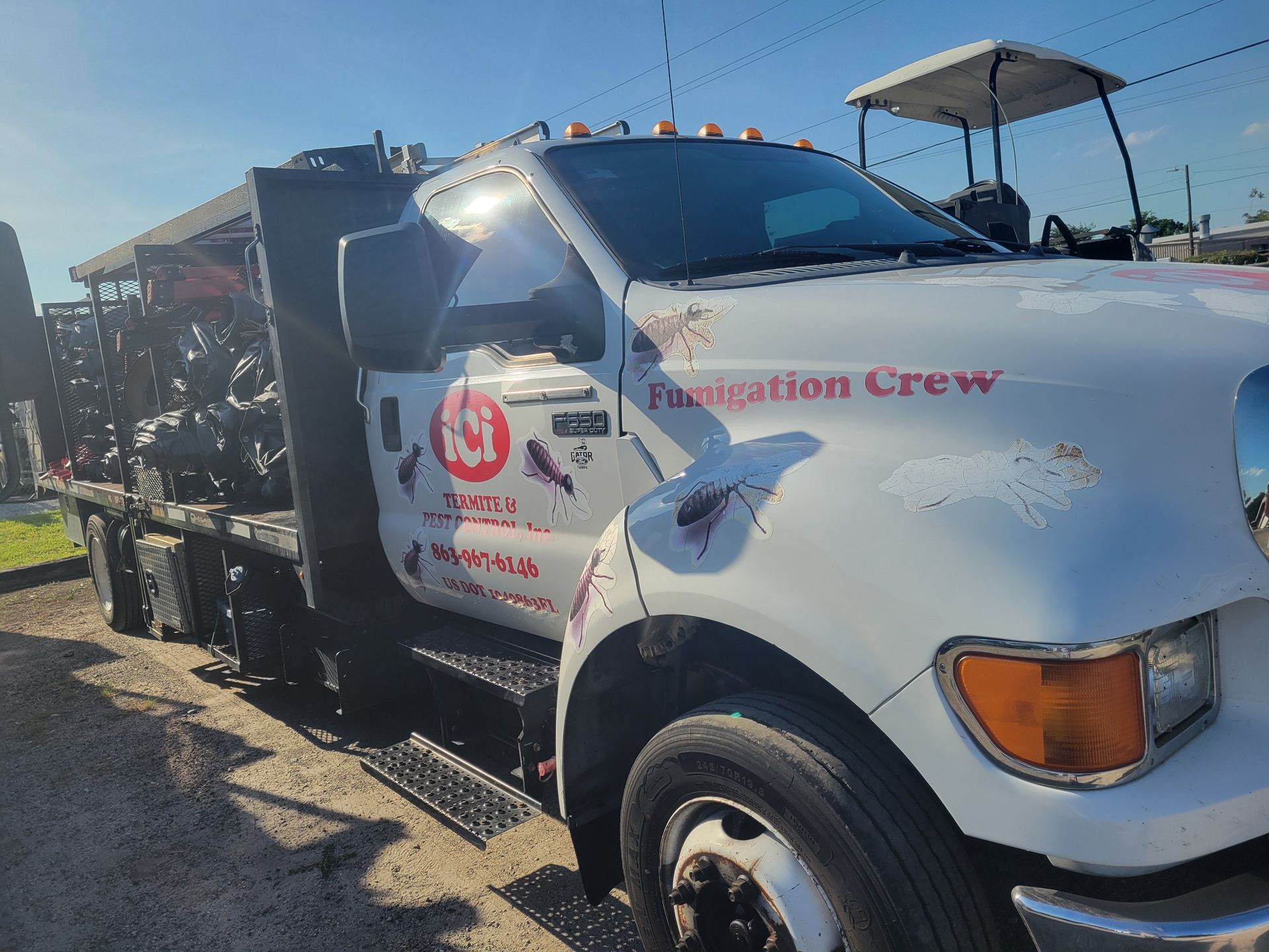 A white tow truck is parked on the side of the road.