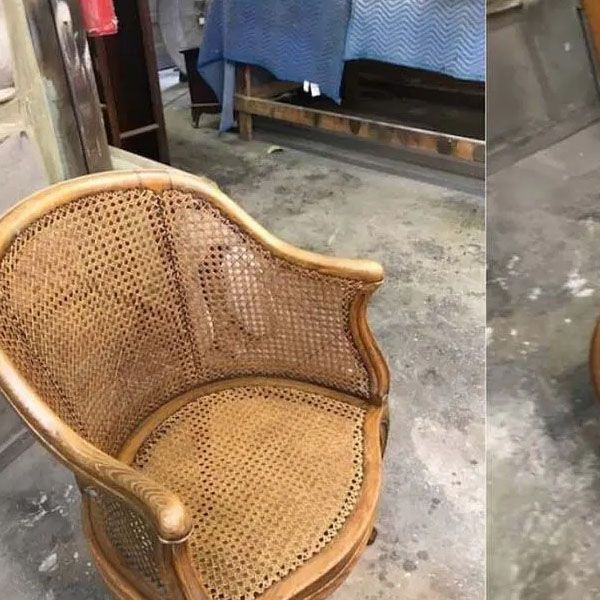 Wicker armchair with curved backrest in a workshop-like room
