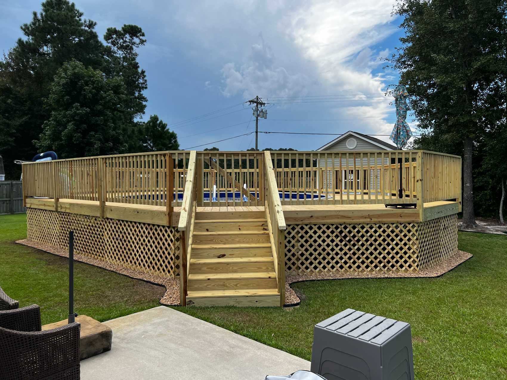 A large wooden deck with stairs leading up to it