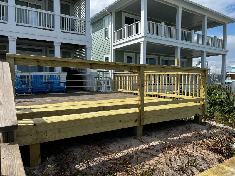 A wooden deck is being built in front of a house.