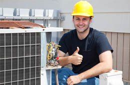 A repairman is done repairing an air conditioner