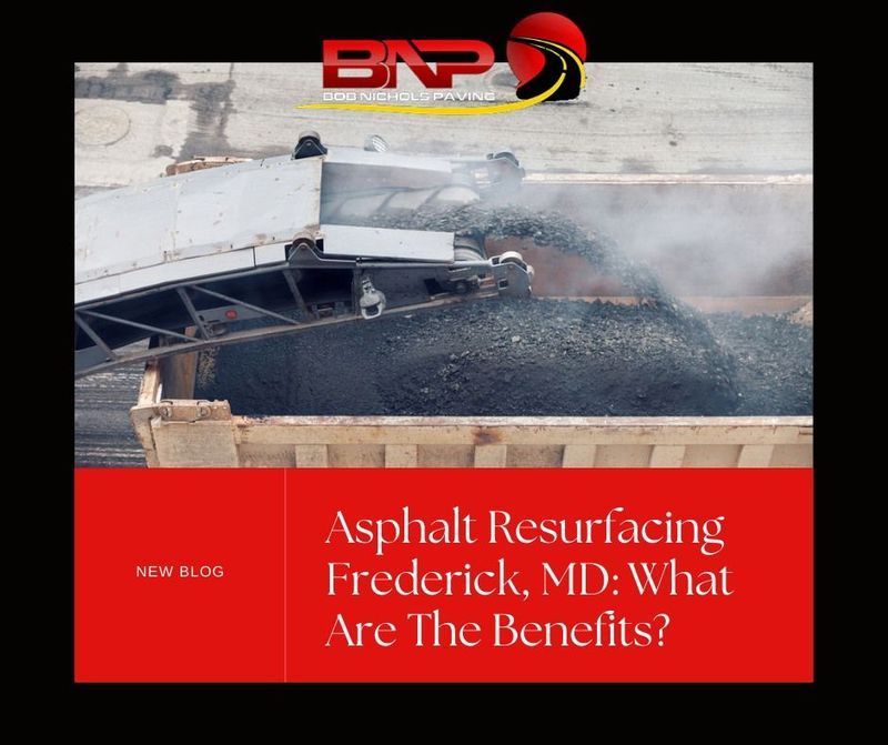 Construction equipment transfers asphalt into a truck bed, with text promoting a blog on asphalt resurfacing in Frederick, MD.