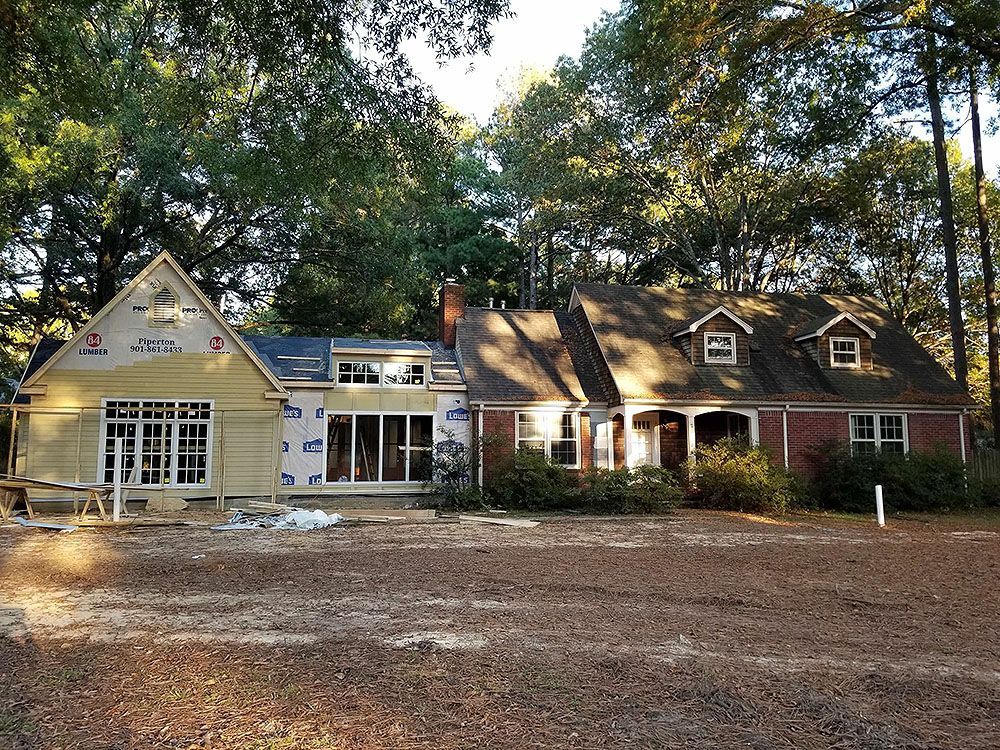 Exterior (In Progress) - House undergoing renovation; new construction on left, older brick on right.