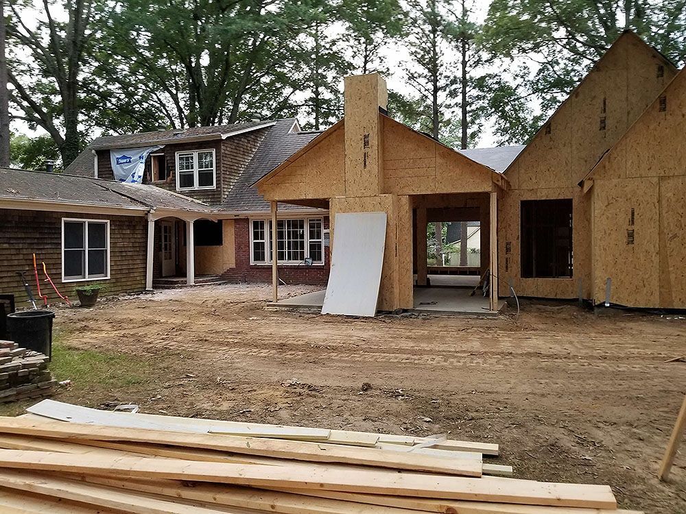 Exterior (In Progress) - House under construction with exposed wood framing; dirt lot.