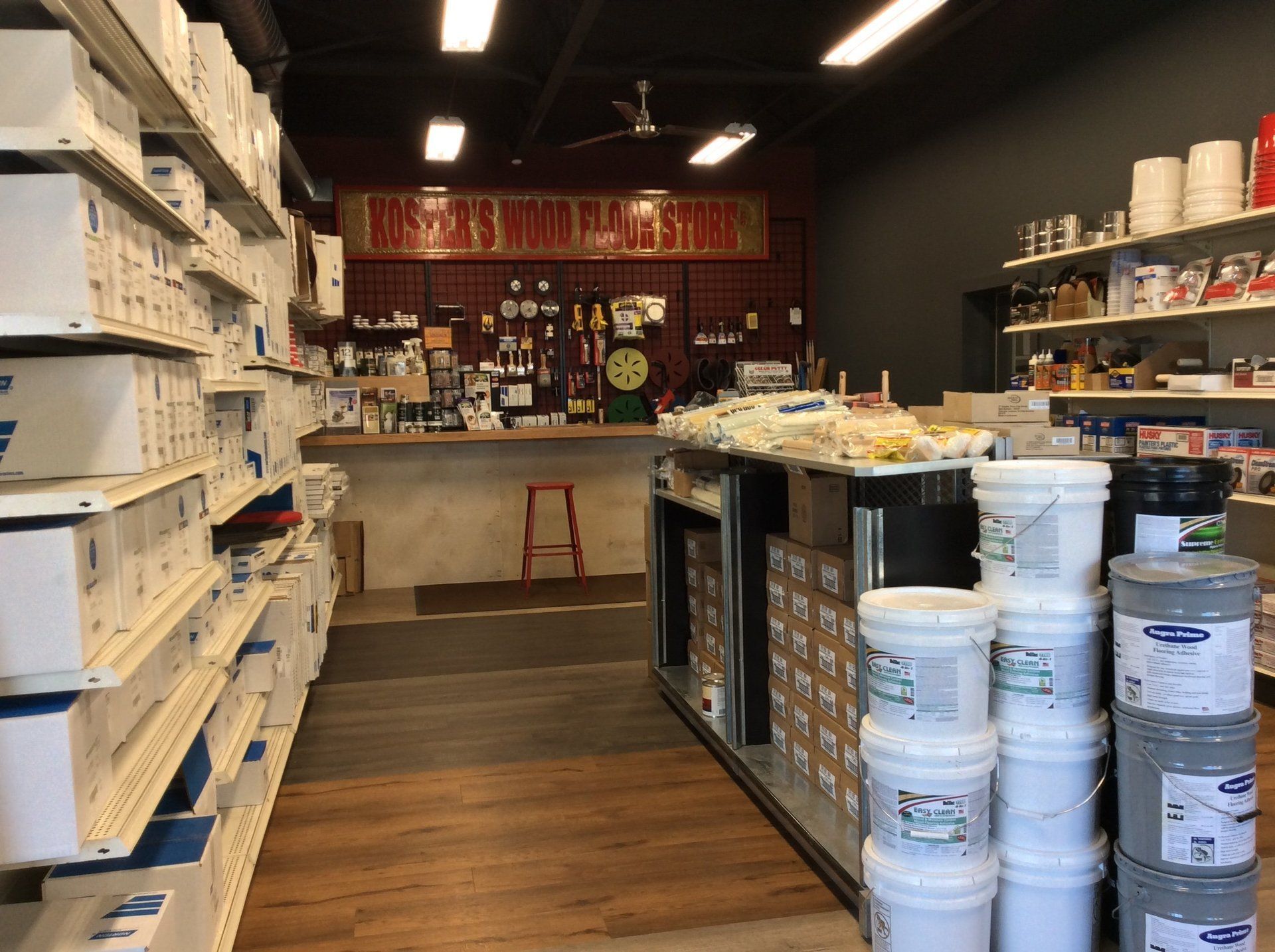 A store filled with lots of shelves and buckets of paint