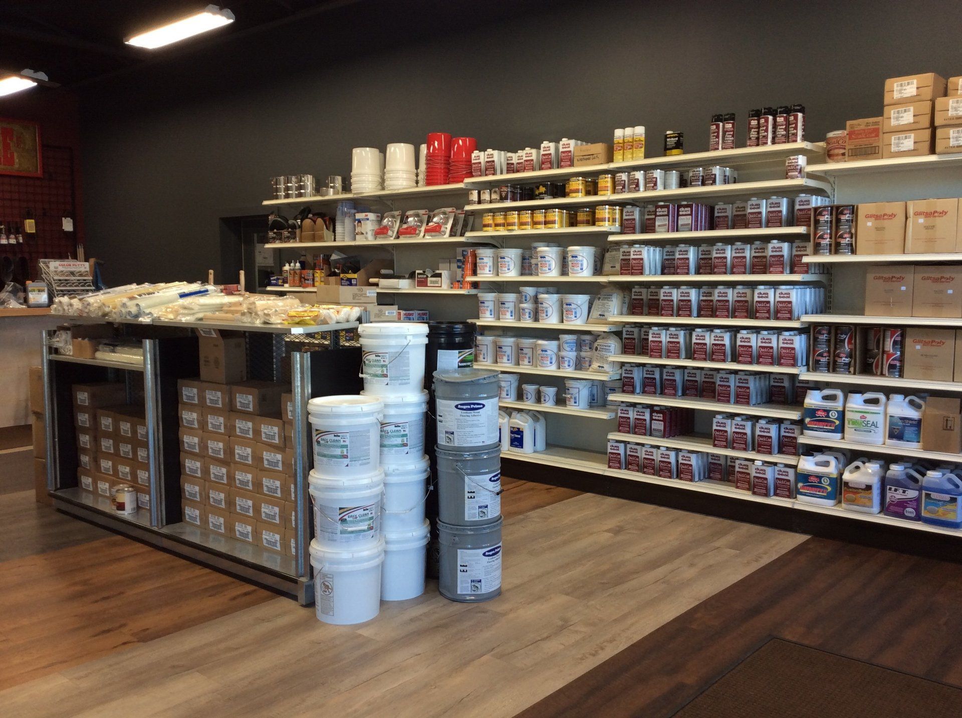 A store filled with lots of shelves and buckets of paint.