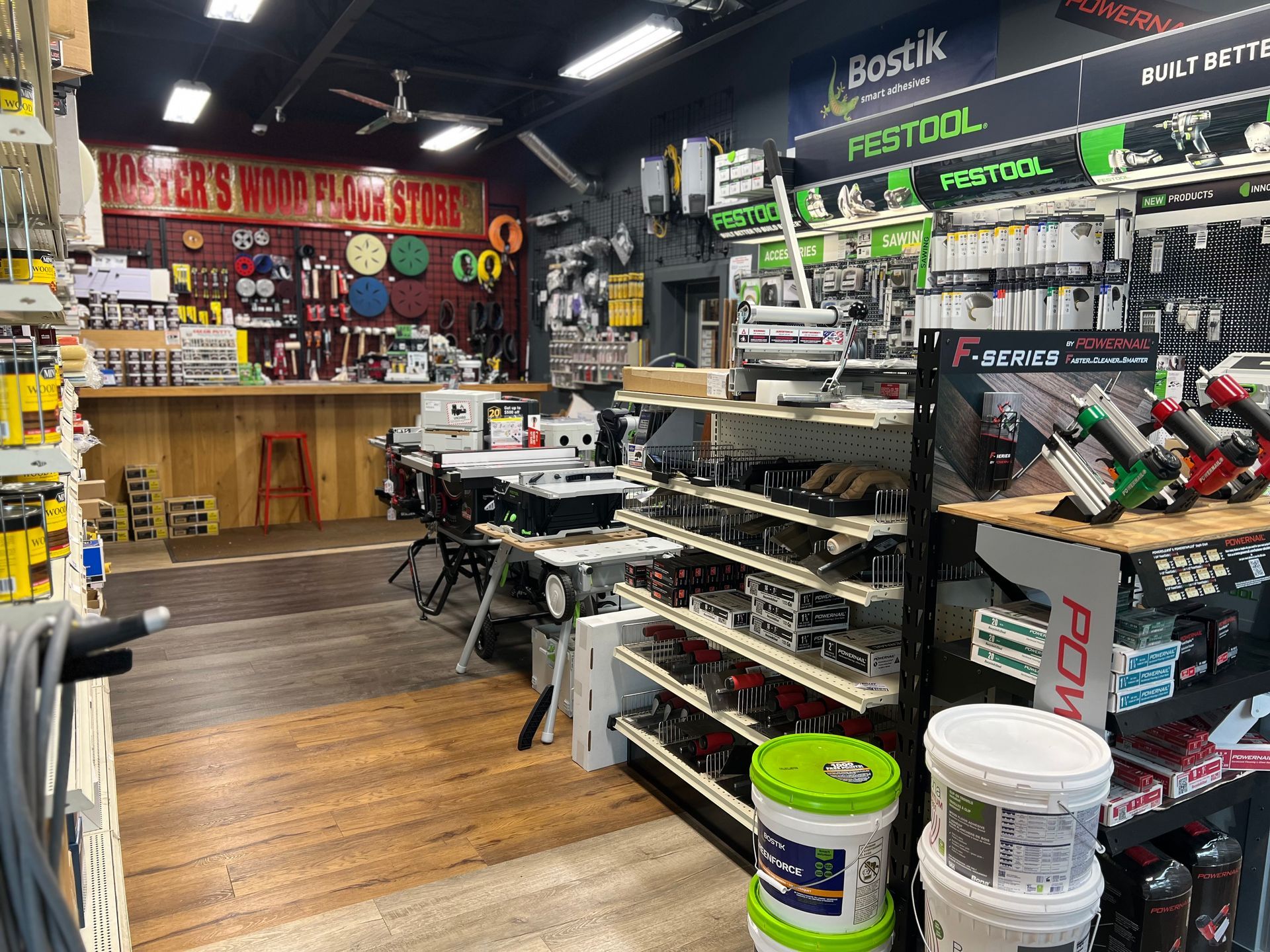 A store filled with lots of shelves and buckets of paint