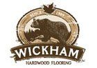 The logo for wickham hardwood flooring has a bear on it.