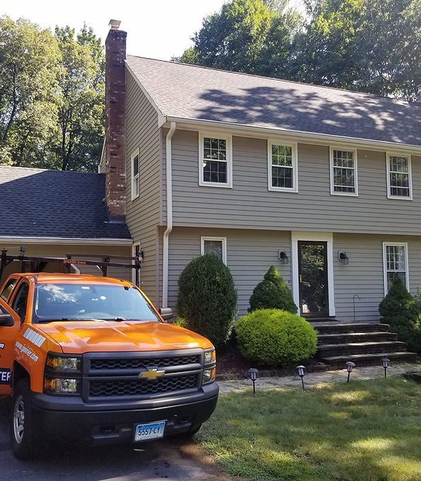 an orange truck is parked in front of a house